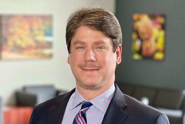 Man posing for a headshot in a suit.