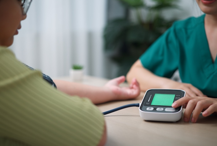 Female patient looking at monitor with nurse