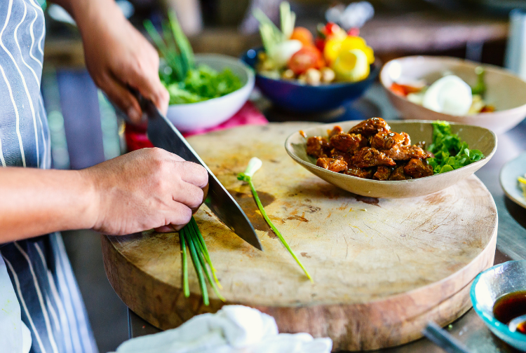 Person chopping greens in the kitchen