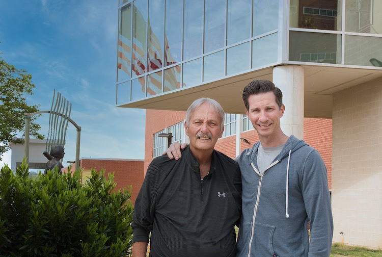 Father and son stand outside of a VCU Health building.