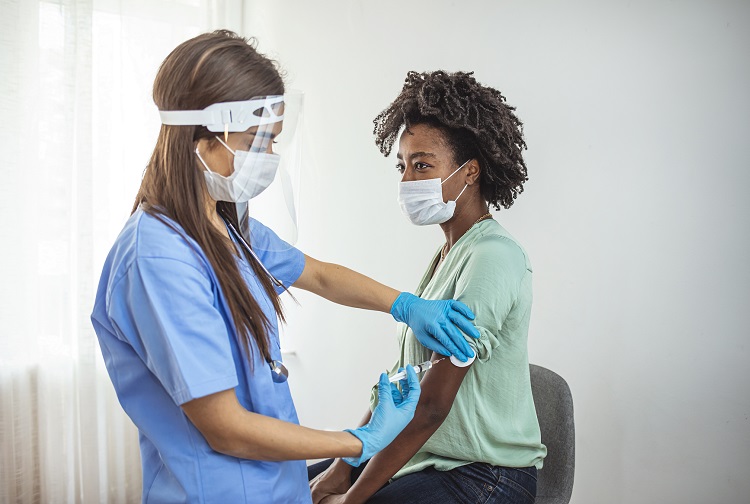 A nurse administers a vaccination shot to a patient.