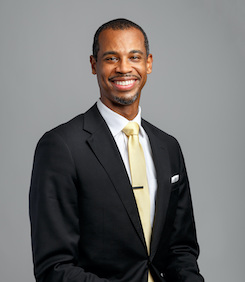 Michael Elliot in front of a gray backdrop