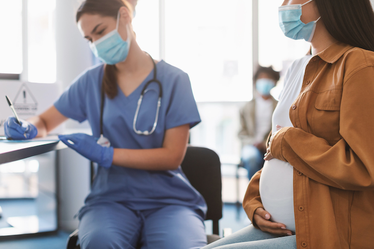 Nurse and Pregnant Woman in Hospital